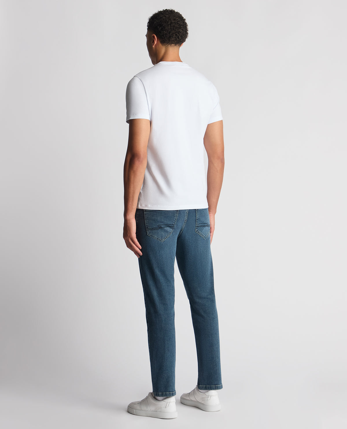 Man wearing a blue Roman Modern Straight Fit Cotton-Stretch Jean