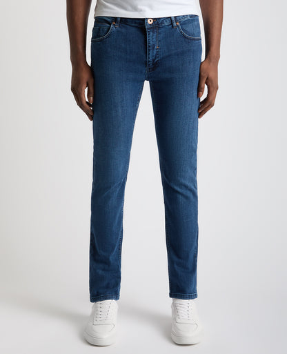 Man wearing a blue Apollo Slim Leg Cotton Stretch Jean