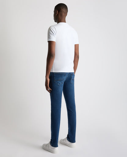 Man wearing a blue Apollo Slim Leg Cotton Stretch Jean