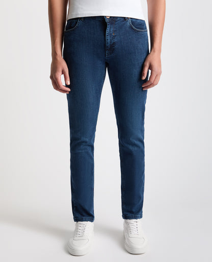 Man wearing a navy Apollo Slim Leg Cotton Stretch Jean