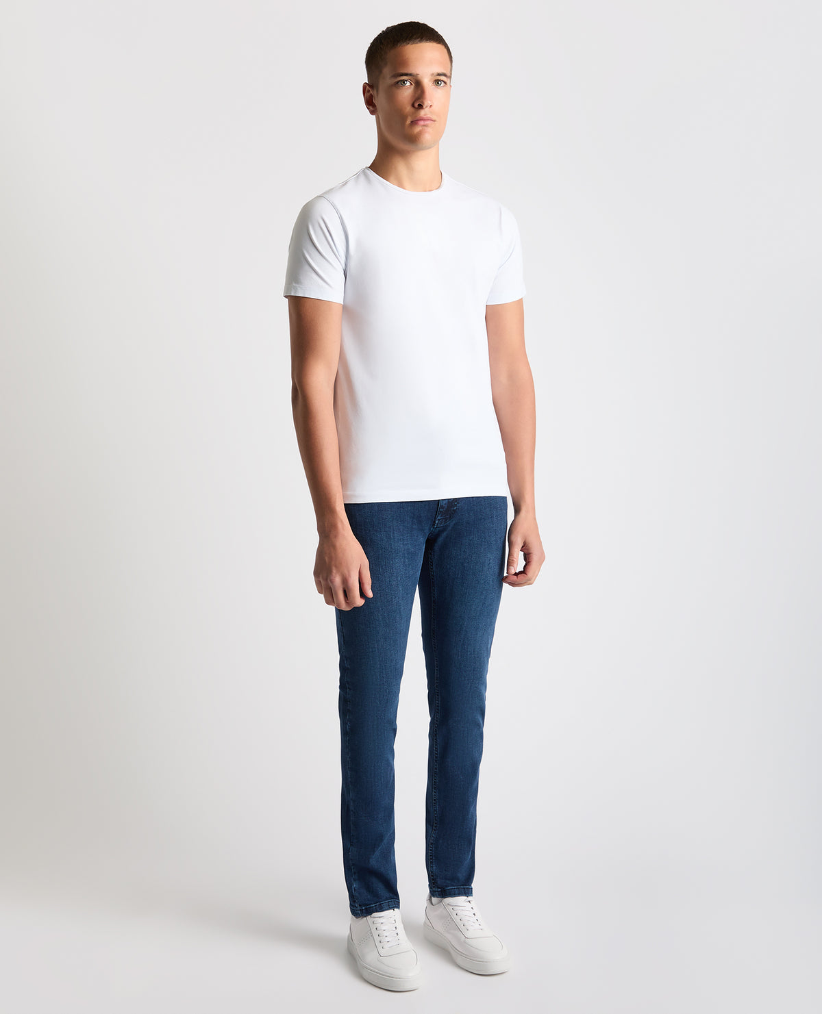 Man wearing a navy Apollo Slim Leg Cotton Stretch Jean