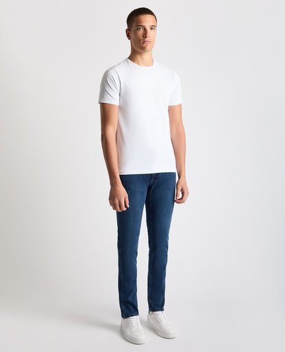 Man wearing a navy Apollo Slim Leg Cotton Stretch Jean