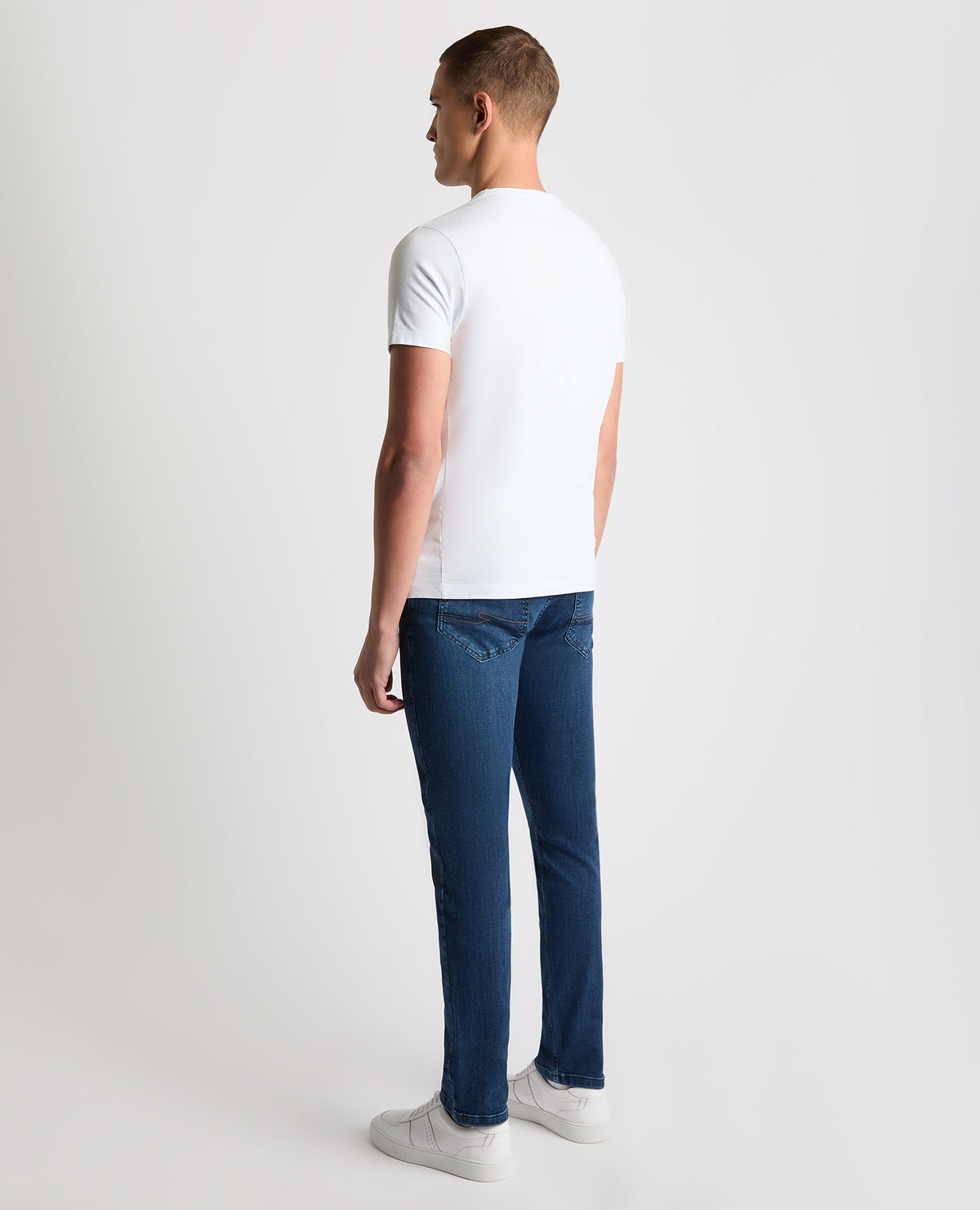 Man wearing a navy Apollo Slim Leg Cotton Stretch Jean