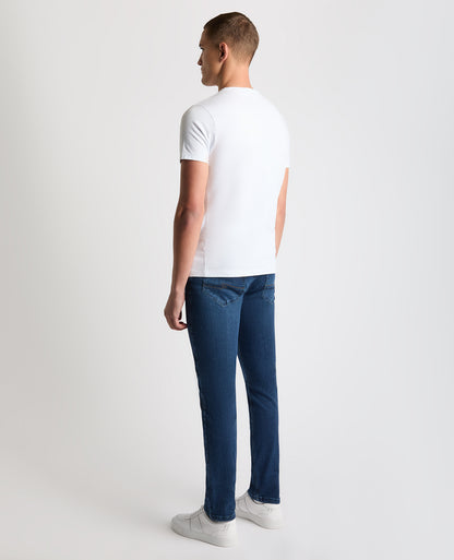 Man wearing a navy Apollo Slim Leg Cotton Stretch Jean