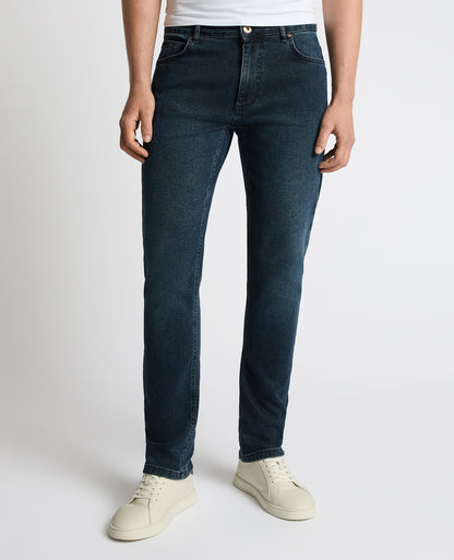 Man wearing a navy Apollo Slim Leg Power Stretch Jeans