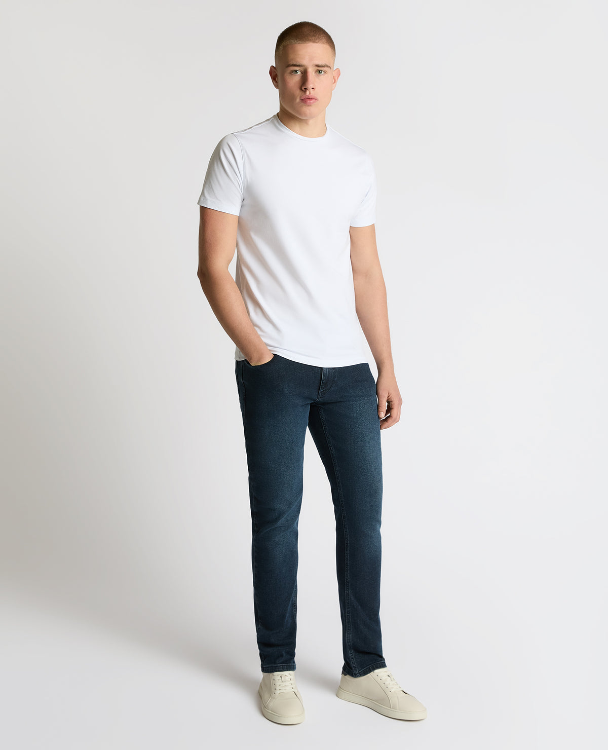 Man wearing a navy Apollo Slim Leg Power Stretch Jeans