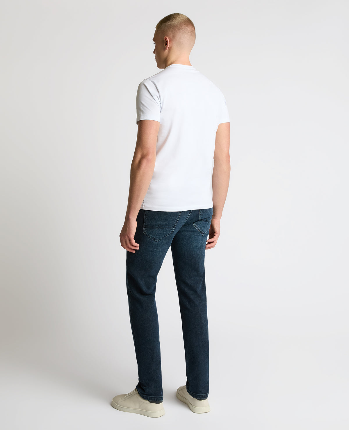 Man wearing a navy Apollo Slim Leg Power Stretch Jeans