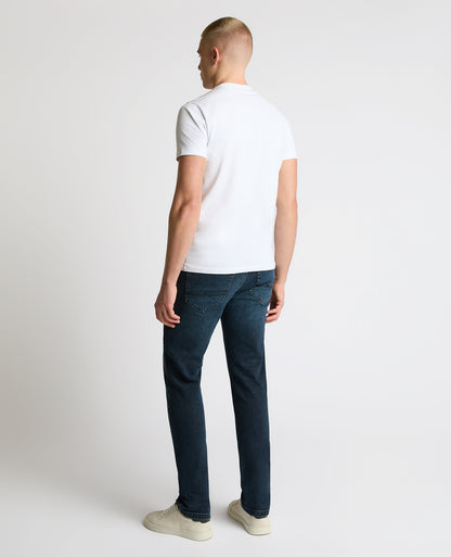 Man wearing a navy Apollo Slim Leg Power Stretch Jeans