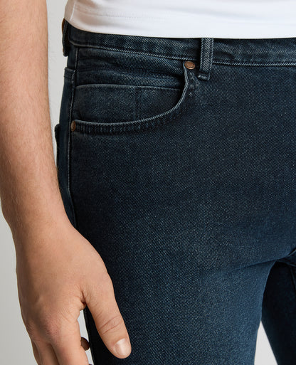 Man wearing a navy Apollo Slim Leg Power Stretch Jeans