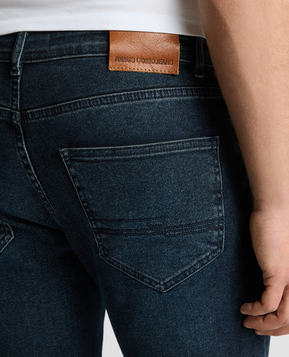 Man wearing a navy Apollo Slim Leg Power Stretch Jeans