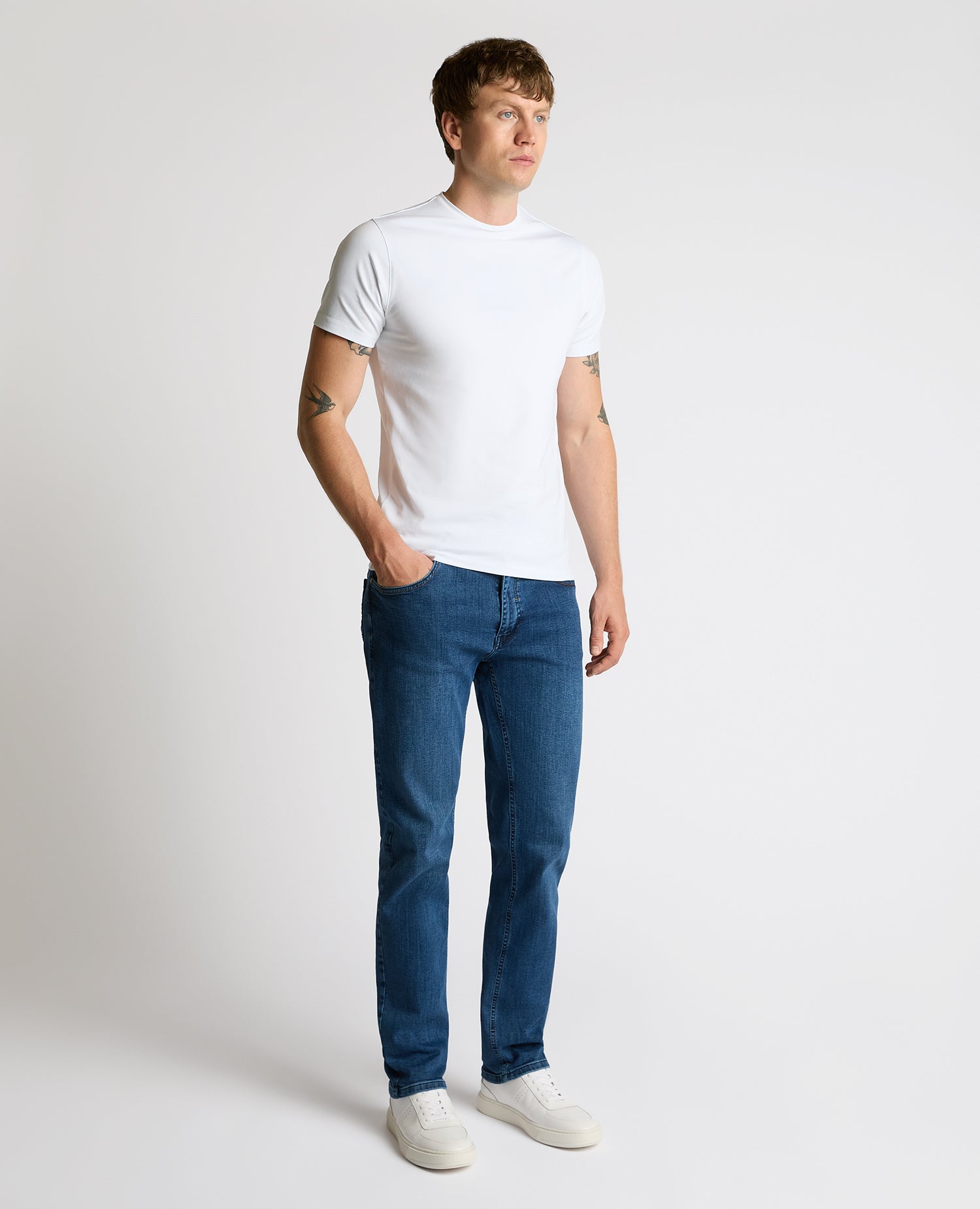 Man wearing a blue Rogan Straight Leg Jeans