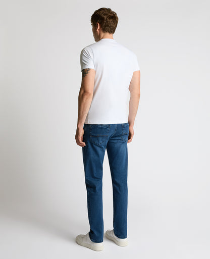 Man wearing a blue Rogan Straight Leg Jeans