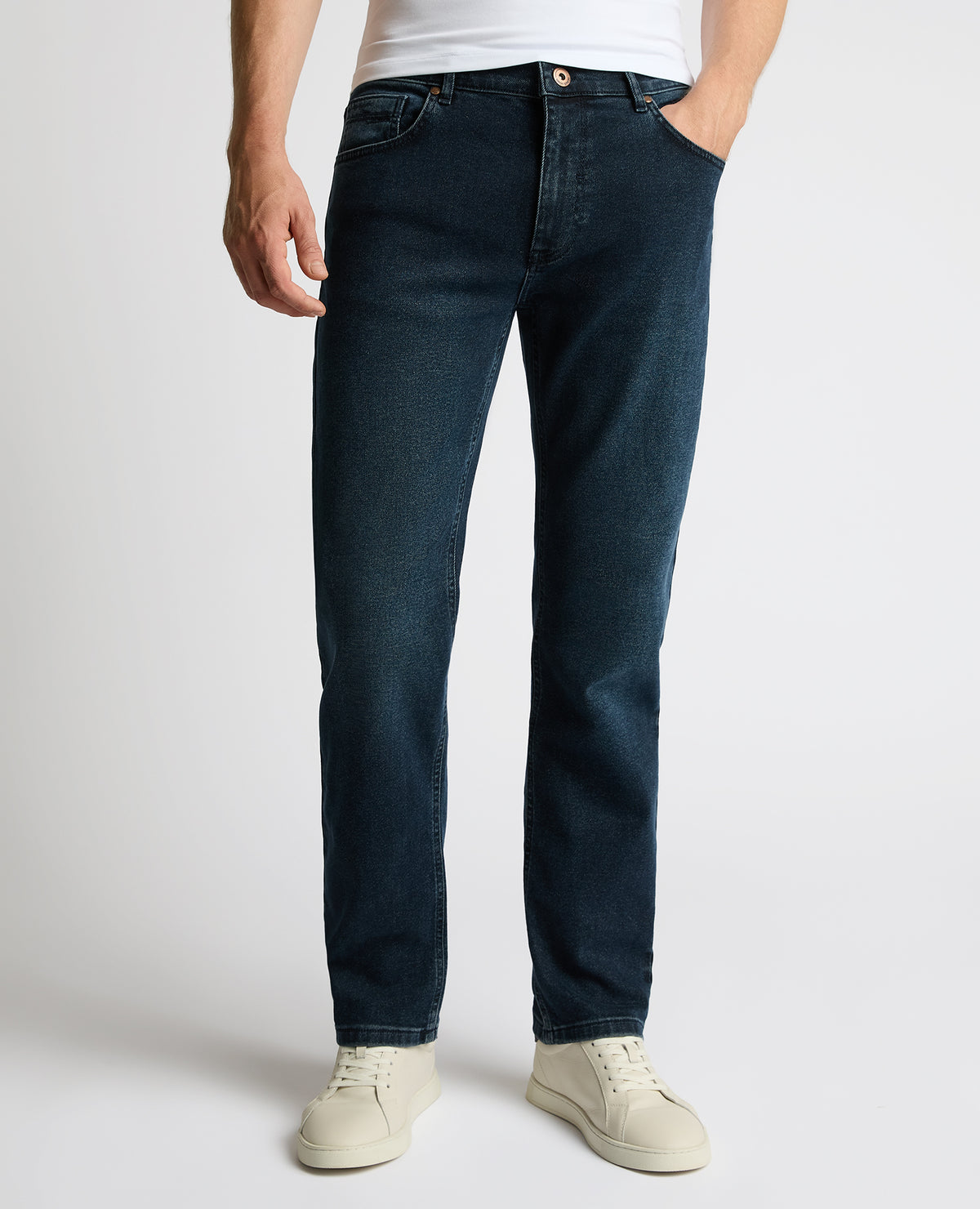 Man wearing a navy Rogan Straight Leg Jeans
