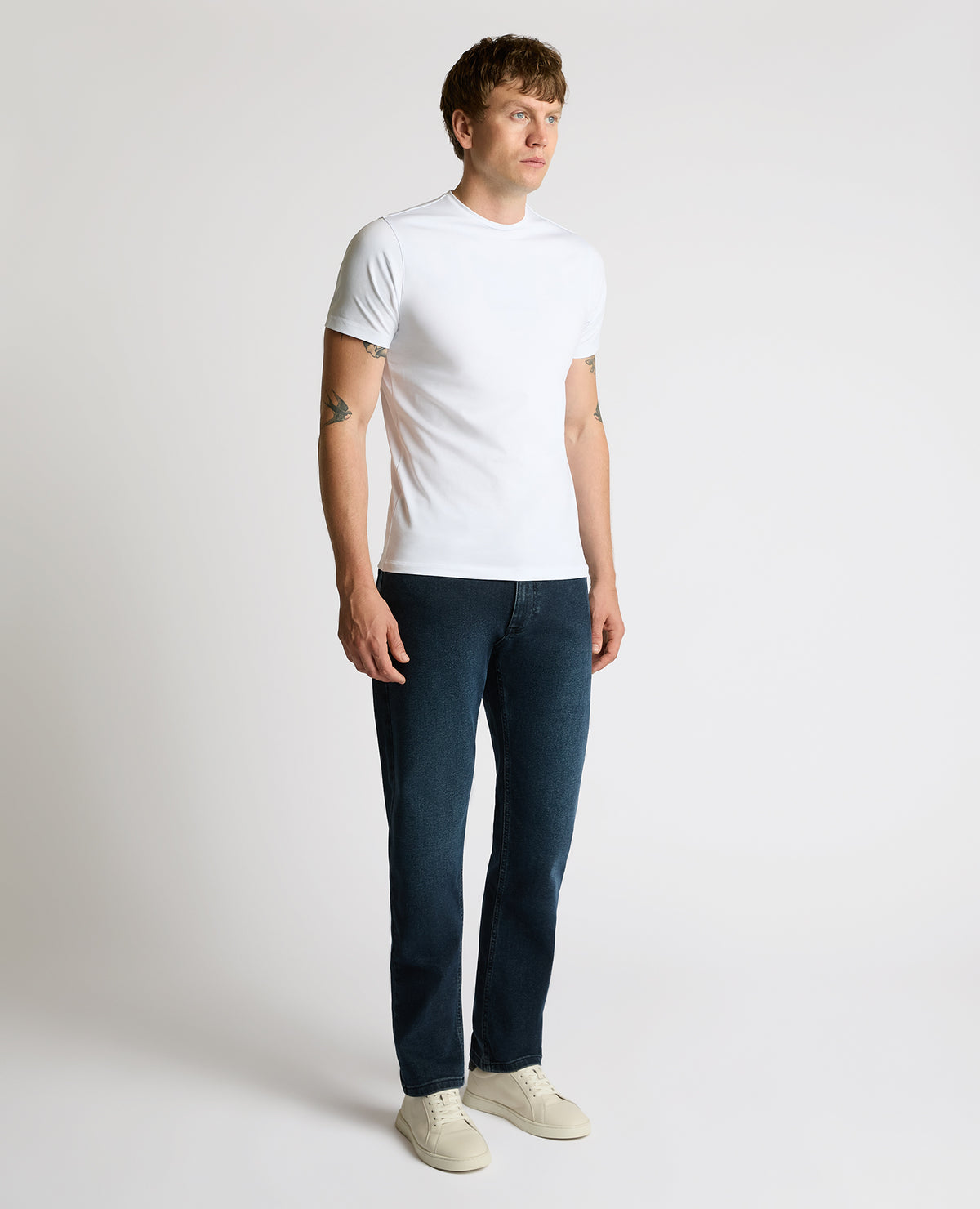 Man wearing a navy Rogan Straight Leg Jeans