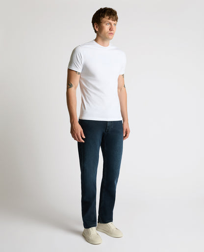 Man wearing a navy Rogan Straight Leg Jeans