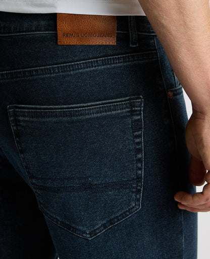 Man wearing a navy Rogan Straight Leg Jeans