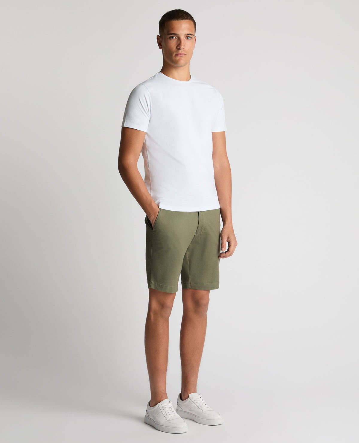 Man wearing a green Slim Leg Cotton-Stretch Chino Short