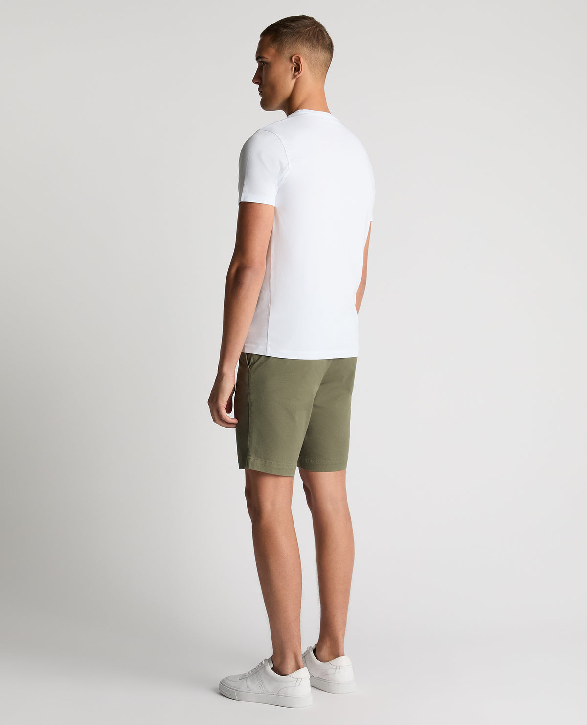 Man wearing a green Slim Leg Cotton-Stretch Chino Short