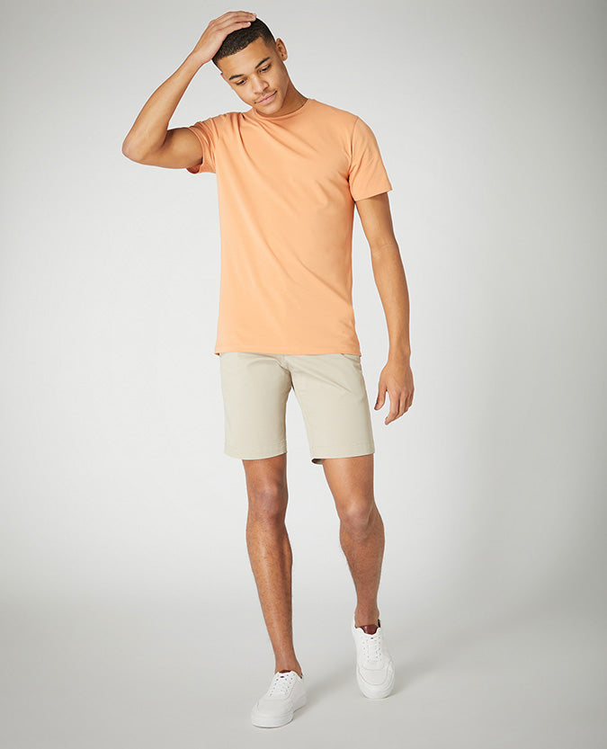 Man wearing a sand Slim Leg Cotton-Stretch Chino Short