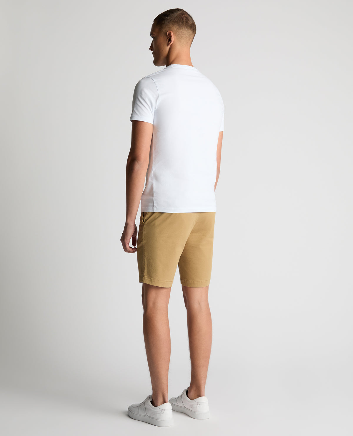 Man wearing a sand Slim Leg Cotton-Stretch Chino Short