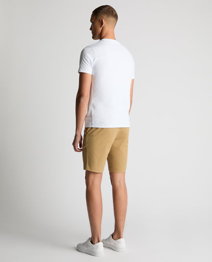 Man wearing a sand Slim Leg Cotton-Stretch Chino Short