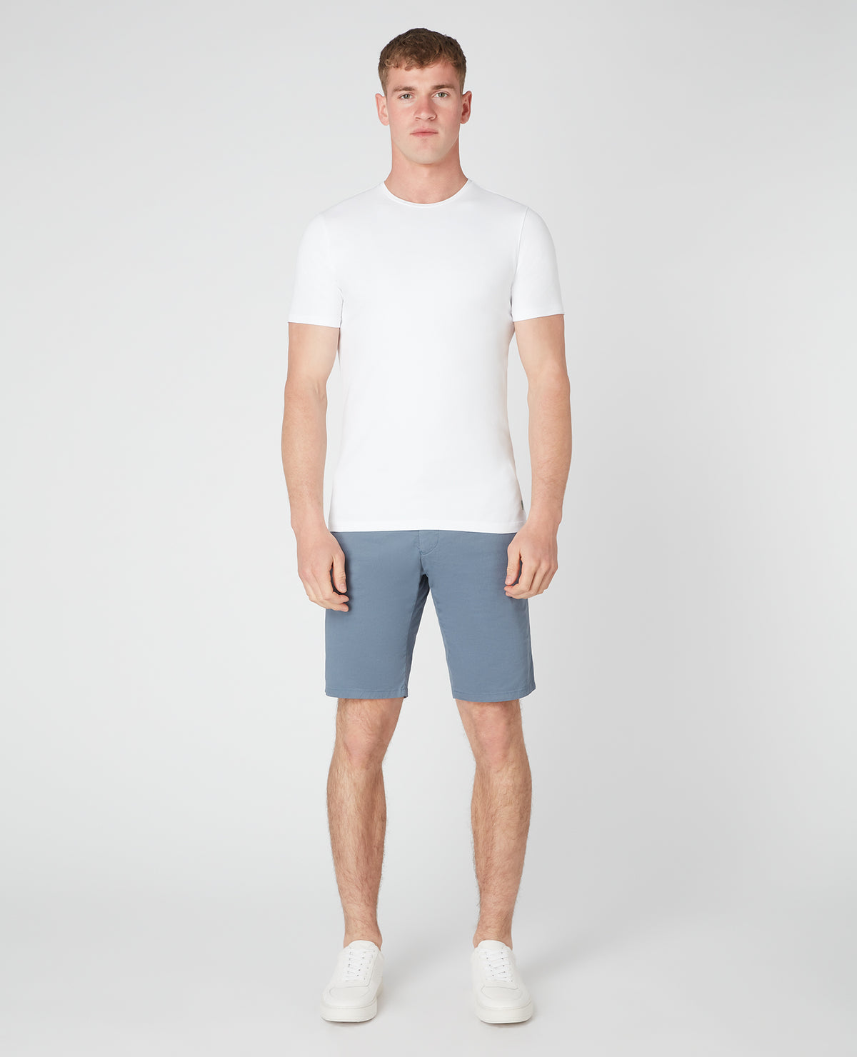 Man wearing a blue Slim Leg Cotton-Stretch Chino Short