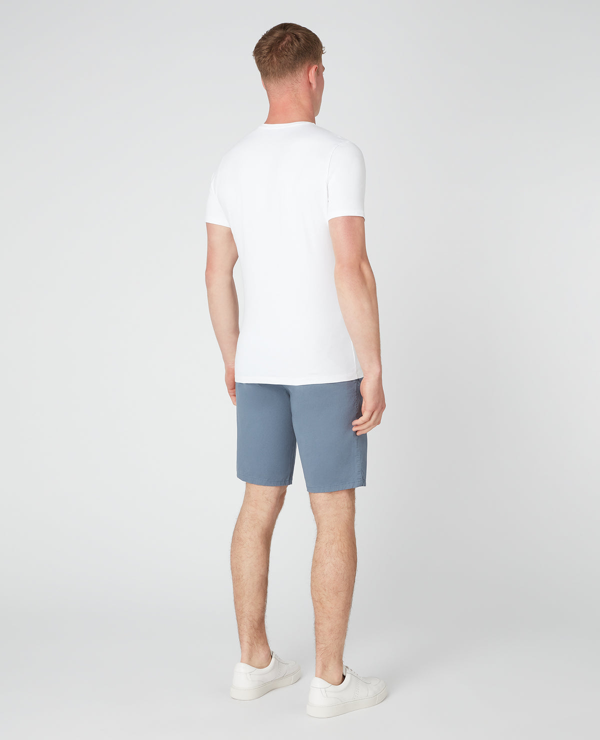 Man wearing a blue Slim Leg Cotton-Stretch Chino Short