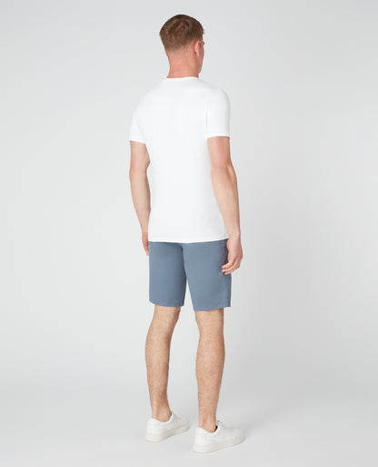 Man wearing a blue Slim Leg Cotton-Stretch Chino Short