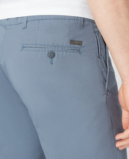 Man wearing a blue Slim Leg Cotton-Stretch Chino Short