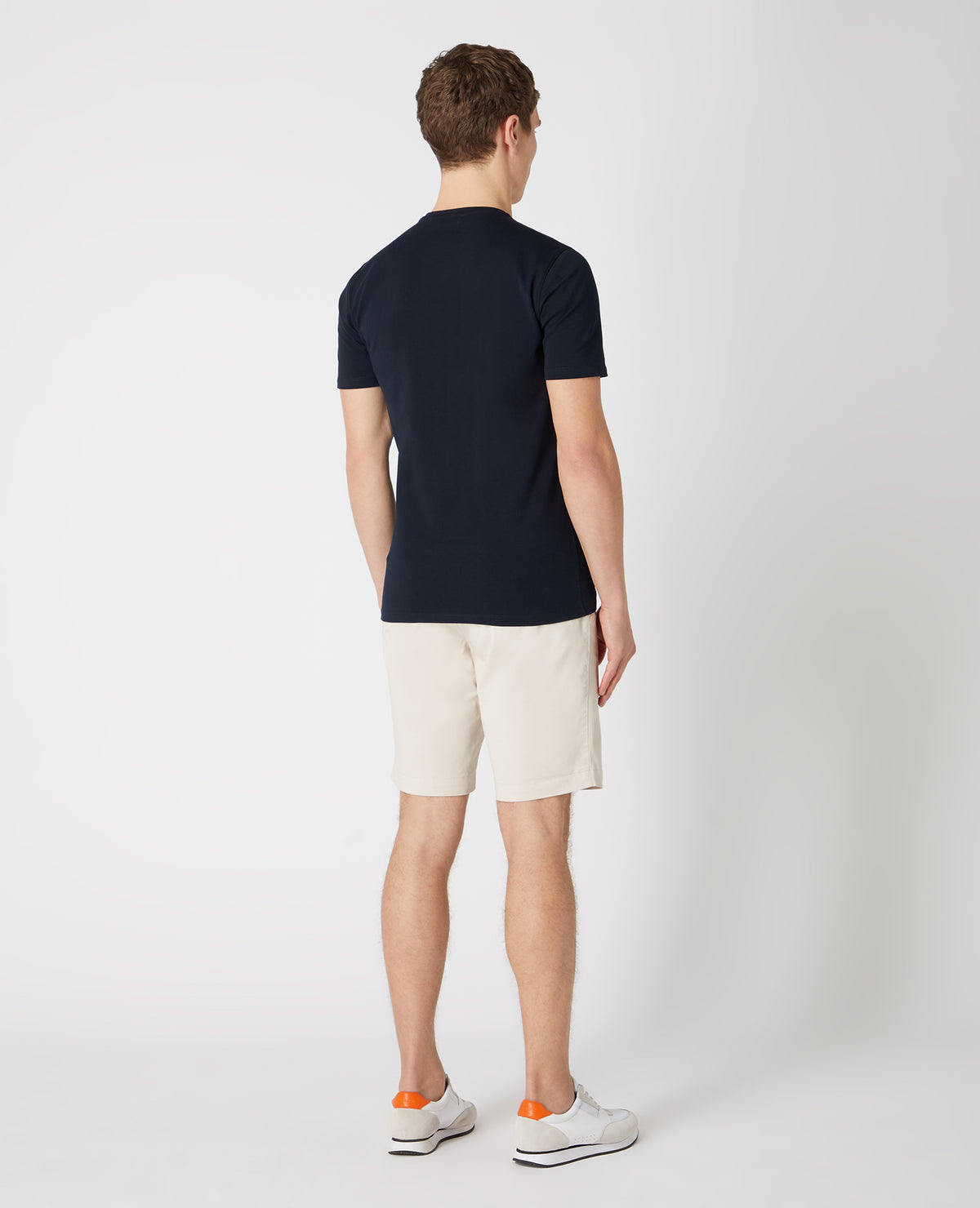 Man wearing a sand Slim Leg Cotton-Stretch Chino Short