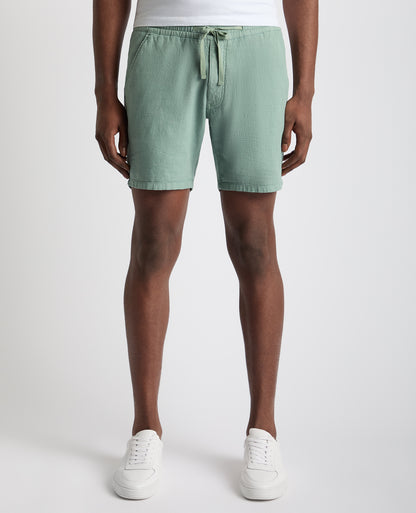 Man wearing a green Slim Fit Cotton-Linen Shorts