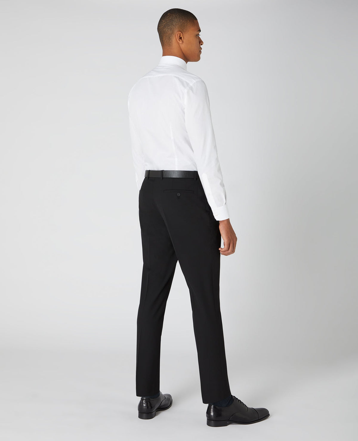 Man wearing a black Tapered Fit Formal Trousers