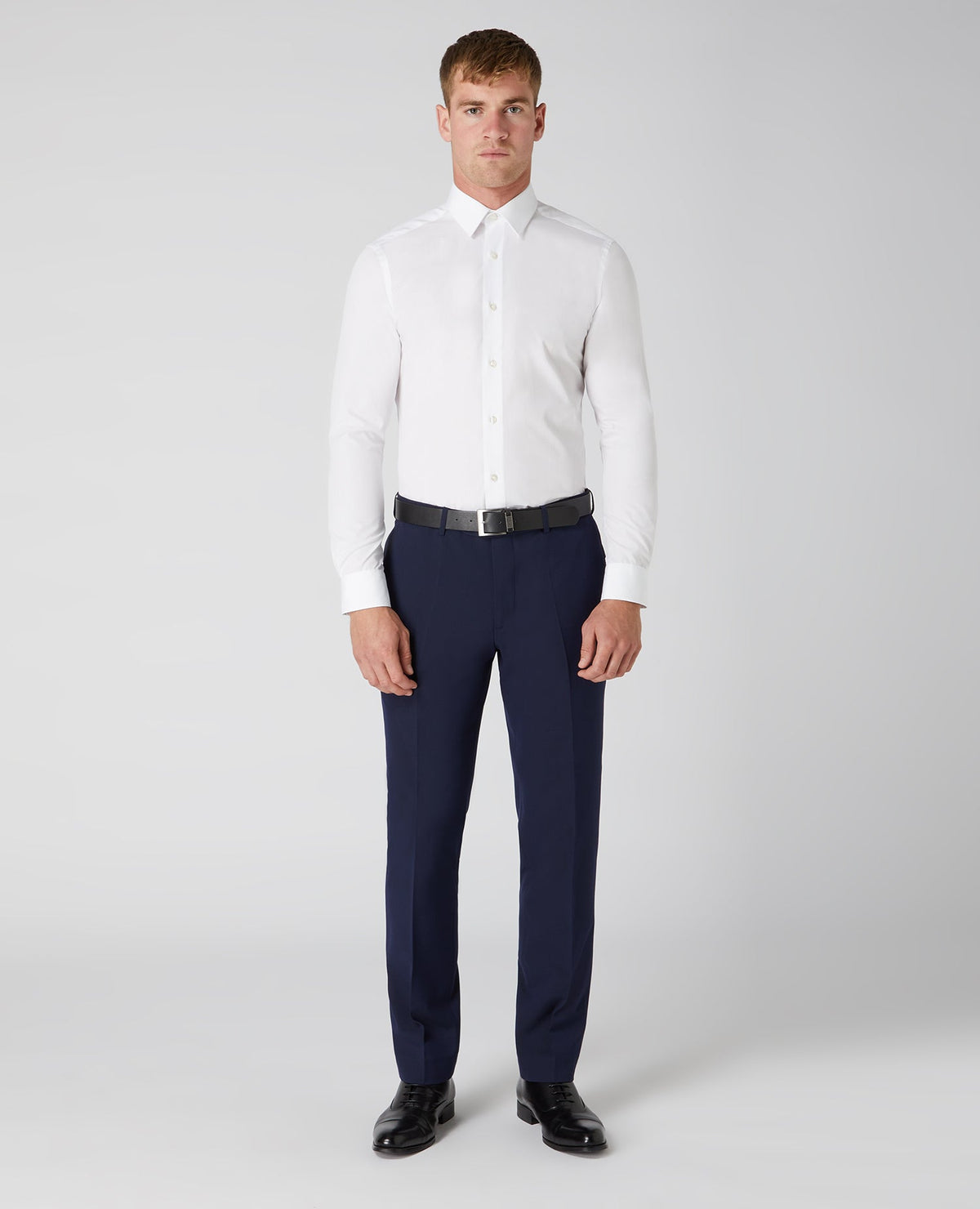 Man wearing a navy Tapered Fit Formal Trousers