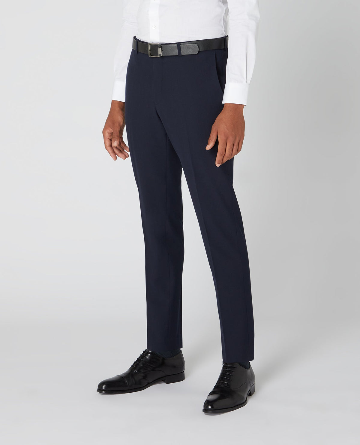 Man wearing a navy Tapered Fit Formal Trousers