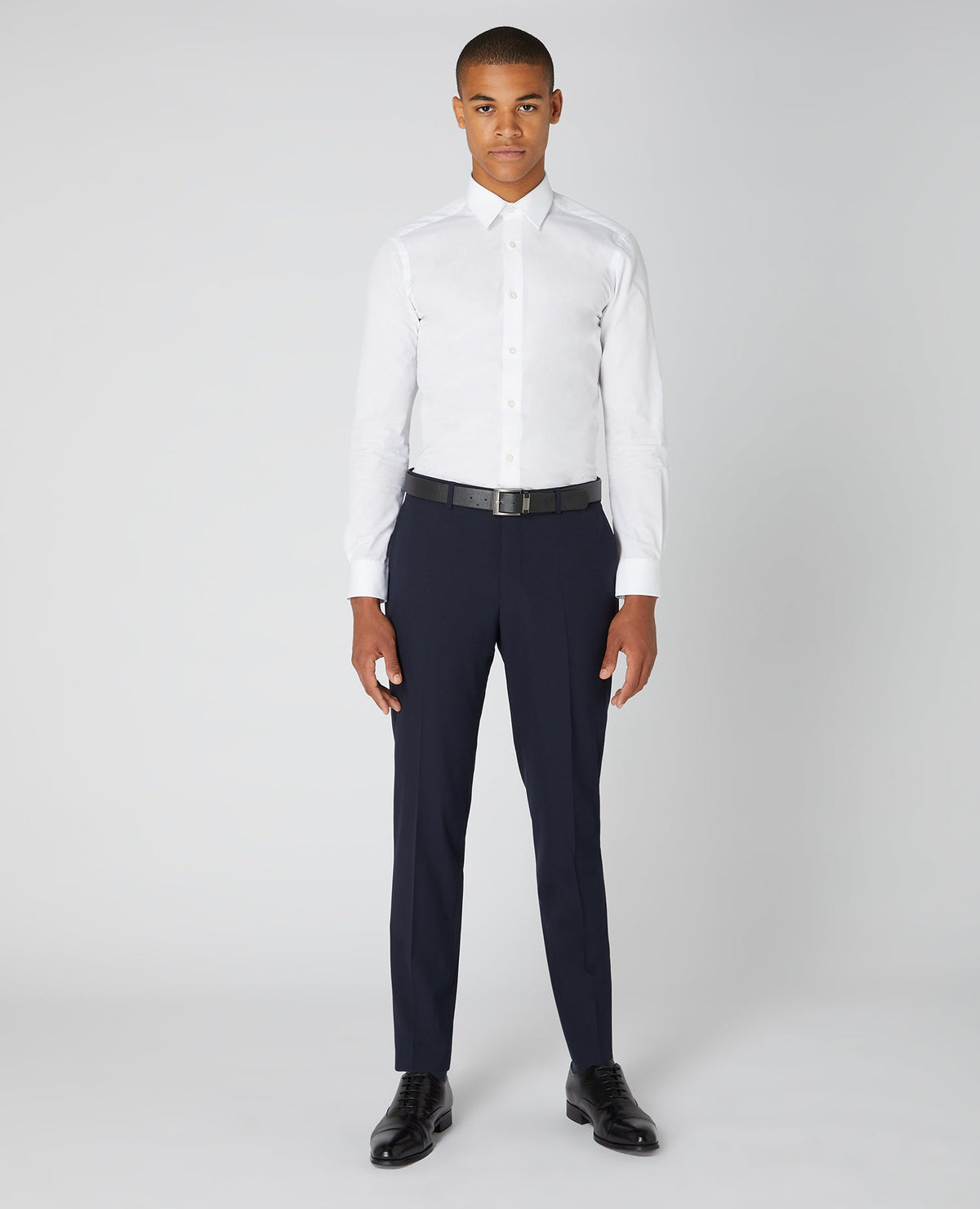 Man wearing a navy Tapered Fit Formal Trousers