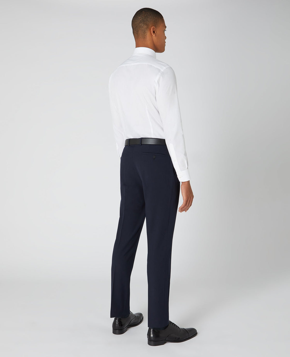 Man wearing a navy Tapered Fit Formal Trousers