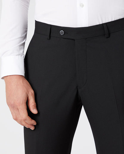 Man wearing a black Tapered Leg Stretch Formal Trousers .