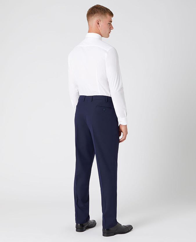 Man wearing a navy Tapered Leg Stretch Formal Trousers .