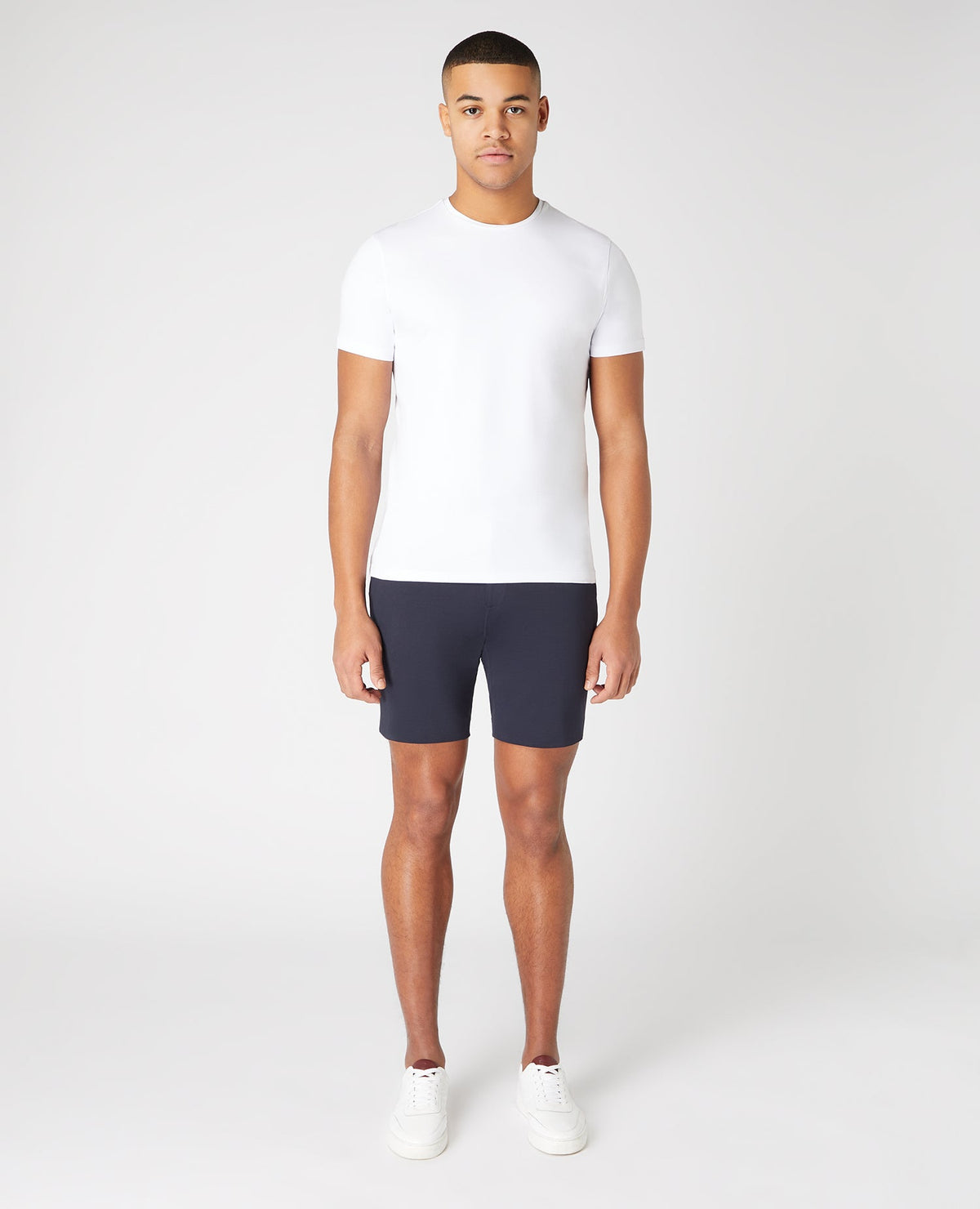 Man wearing a navy Slim Fit Cotton-Stretch Shorts