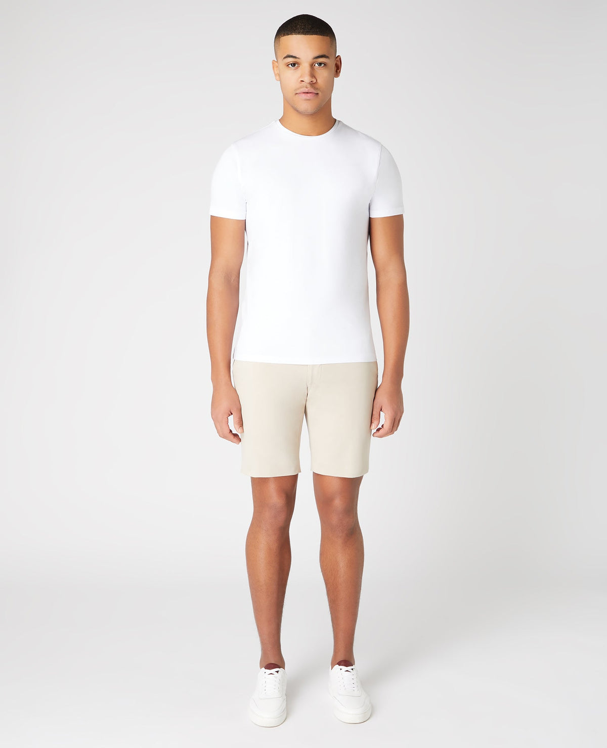 Man wearing a sand Slim Fit Cotton-Stretch Shorts