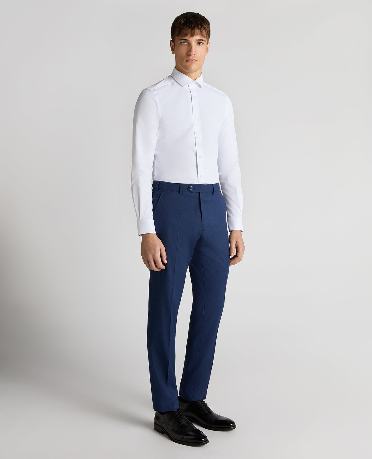Man wearing a blue Slim Leg Checked Stretch Formal Trousers