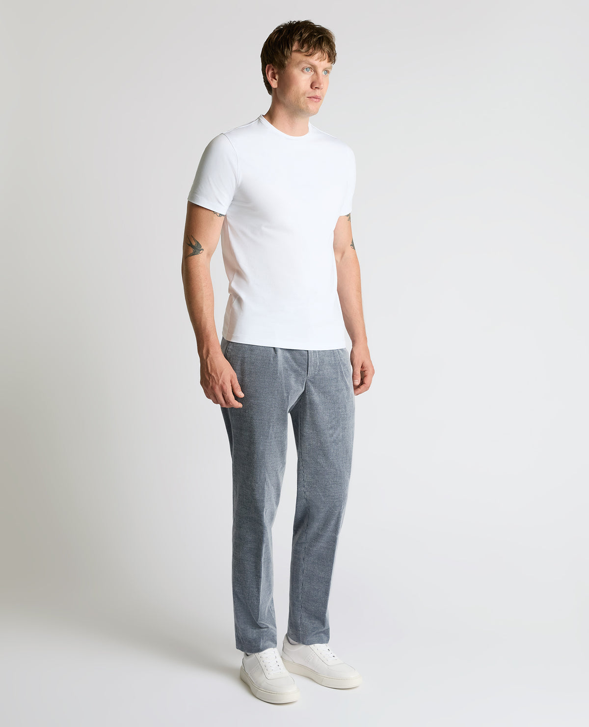Man wearing a blue Slim Leg Stripe Cotton-Stretch Trousers