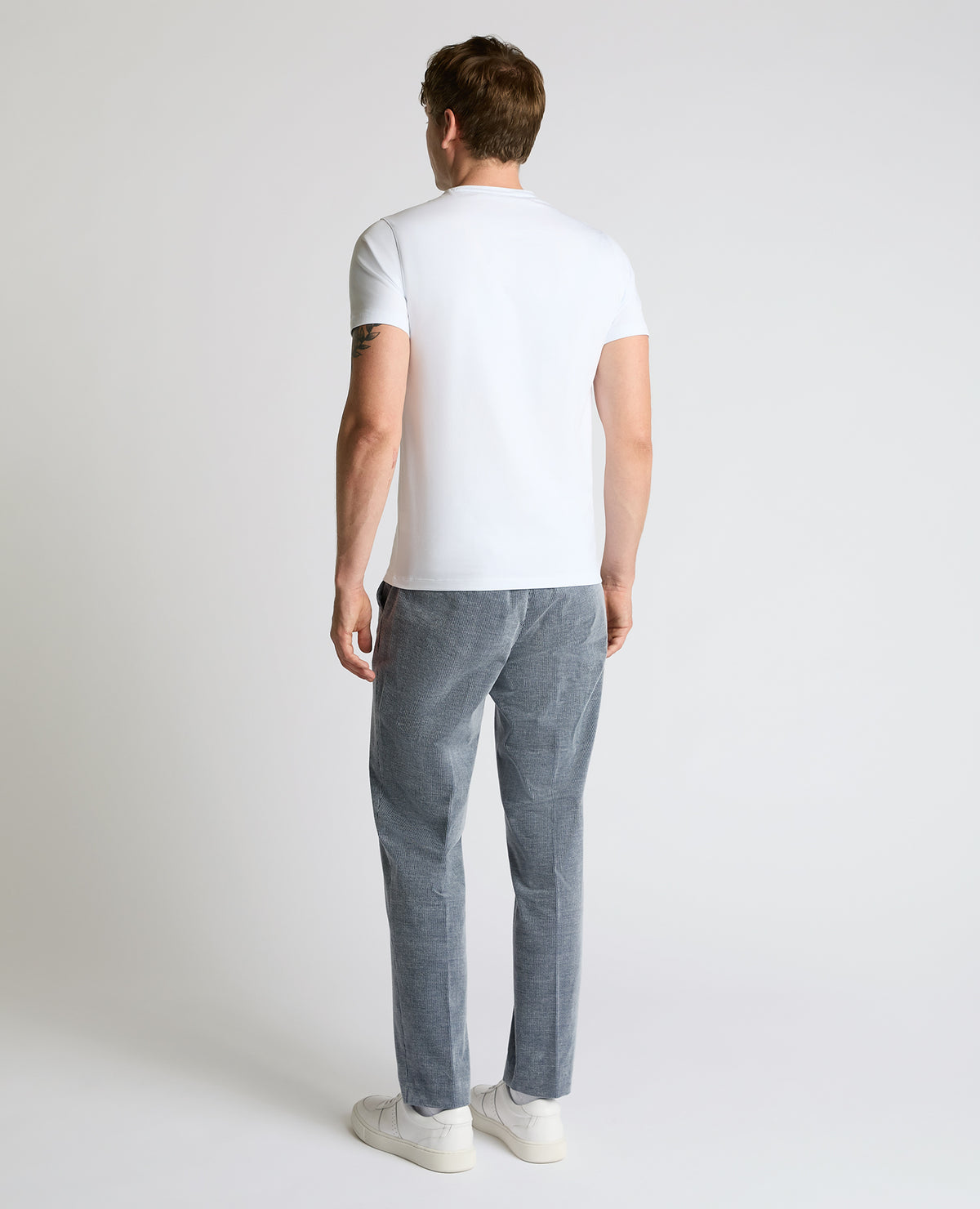 Man wearing a blue Slim Leg Stripe Cotton-Stretch Trousers
