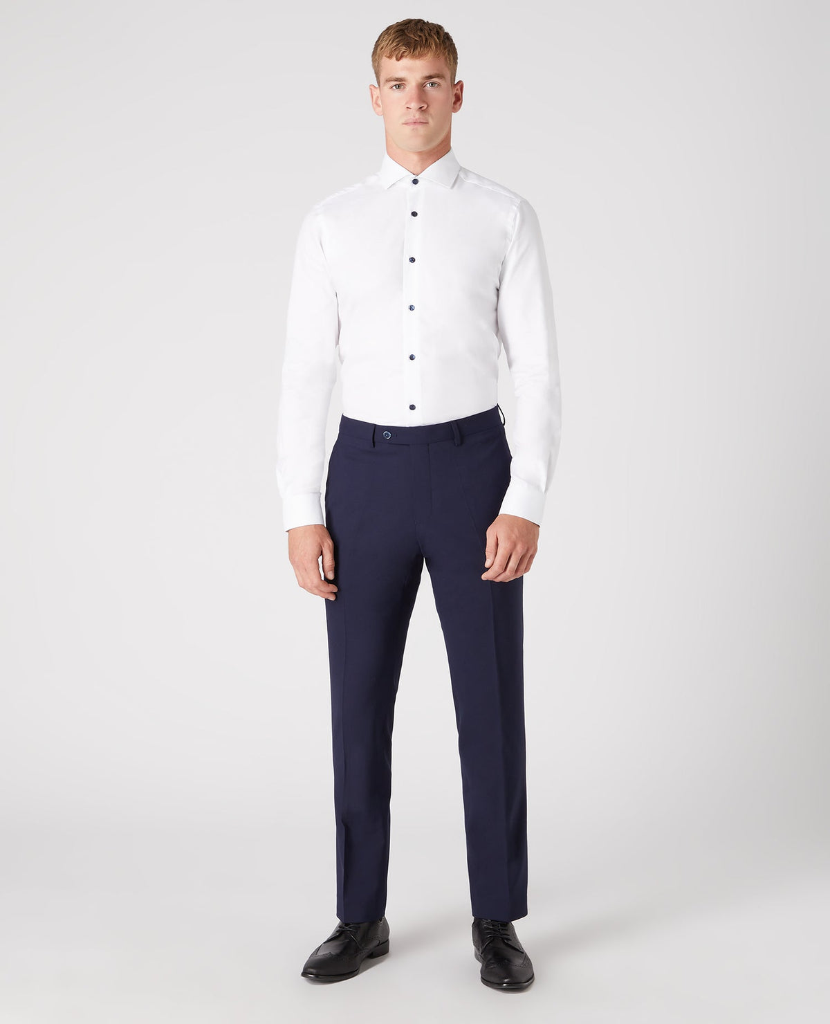 Man wearing a navy Tapered Leg Wool-Blend Suit Trouser