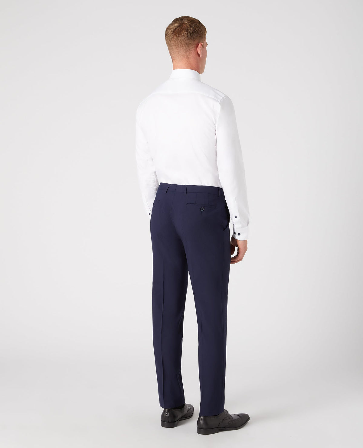 Man wearing a navy Tapered Leg Wool-Blend Suit Trouser