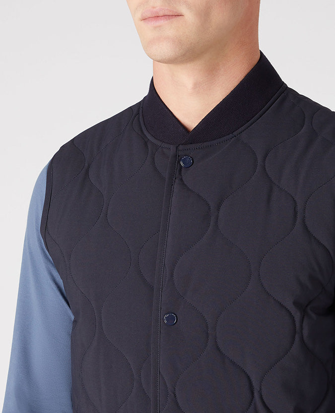 Man wearing a navy Lightweight Quilted Gilet