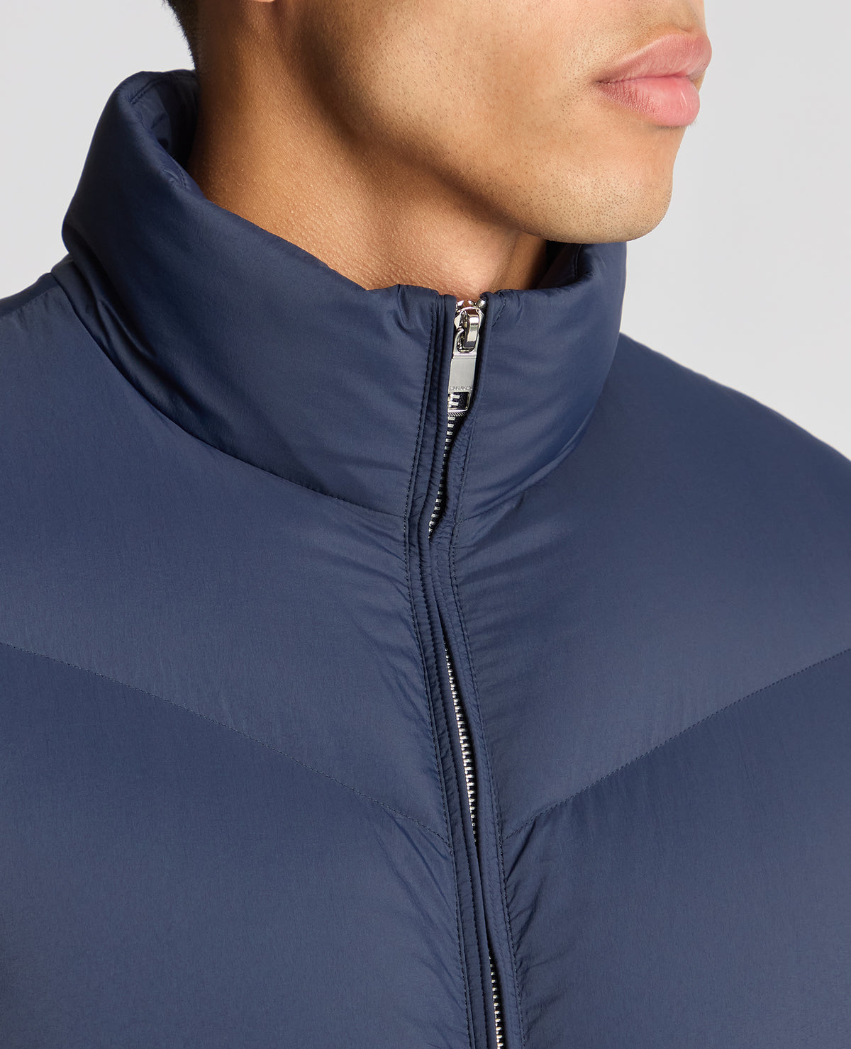 Man wearing a blue Regular Fit Down-Filled Quilted Jacket