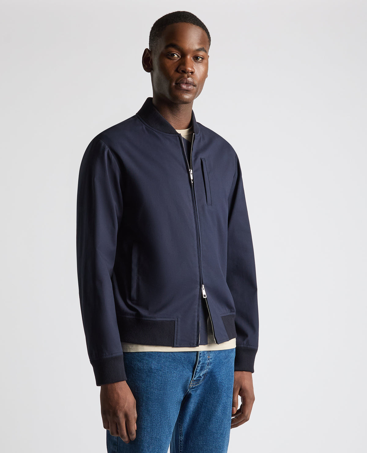 Man wearing a navy Regular Fit Showerproof Bomber Jacket