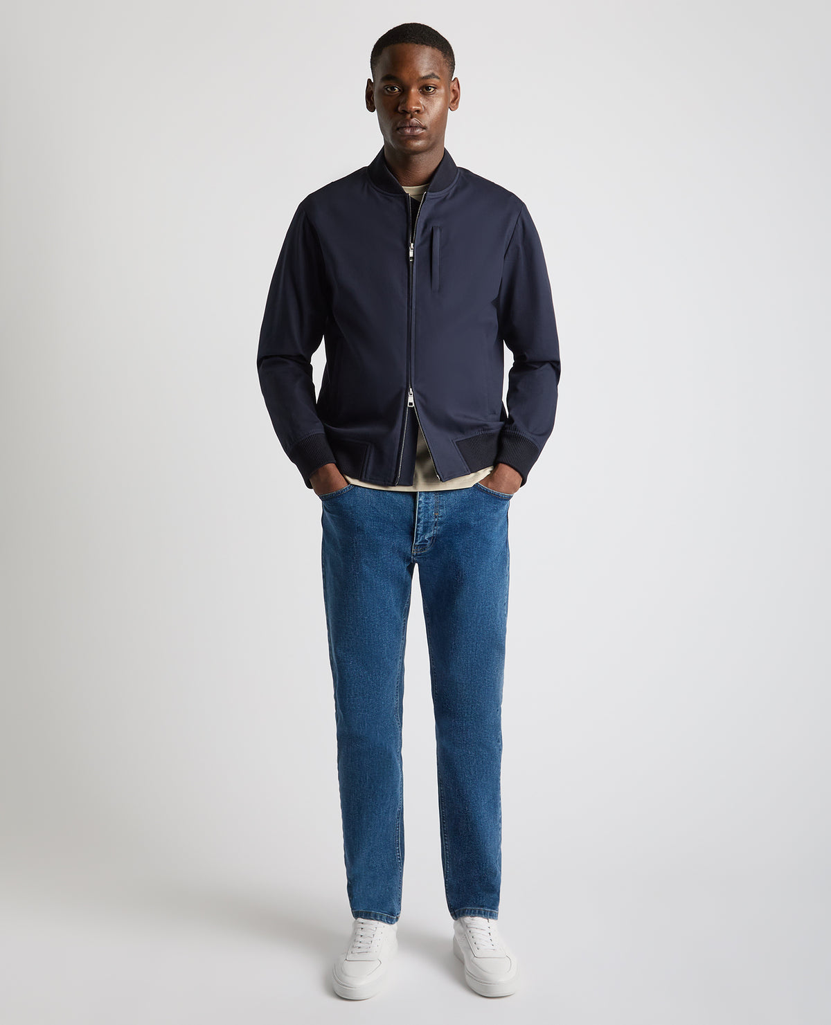 Man wearing a navy Regular Fit Showerproof Bomber Jacket
