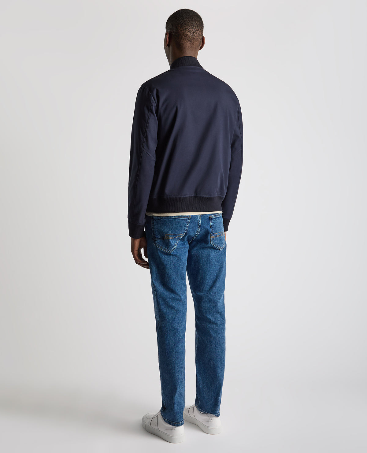 Man wearing a navy Regular Fit Showerproof Bomber Jacket